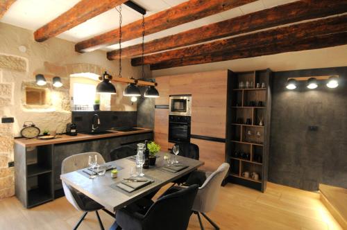 a kitchen and dining room with a table and chairs at Villa Angelina - design stone house in Markovac in Višnjan