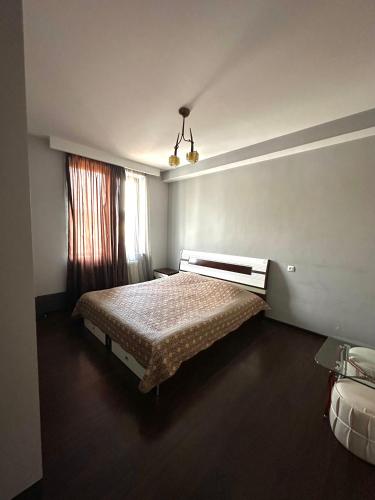 a bedroom with a bed and a window at Elite House in Bakuriani