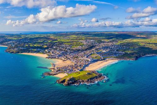 an aerial view of a small island in the ocean at Cosy Cornish Cottage with Firepit & Parking in Newlyn East