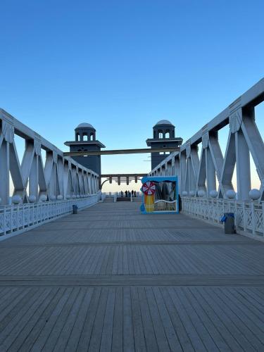 a bridge with a boardwalk with people on it at Front Front Water in Ain Sokhna