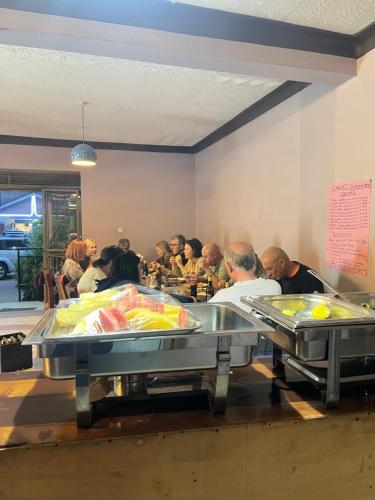 a group of people sitting in a restaurant waiting for food at CAR-NET HOTEL in Kisoro
