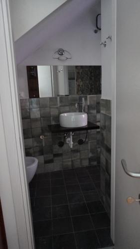 a bathroom with a sink and a toilet at Porto Vecchia Darsena in Savona