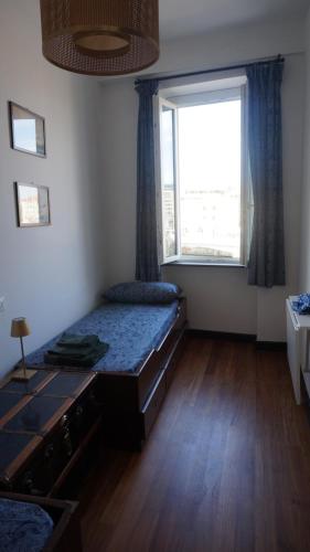 a bedroom with a bed and a large window at Porto Vecchia Darsena in Savona
