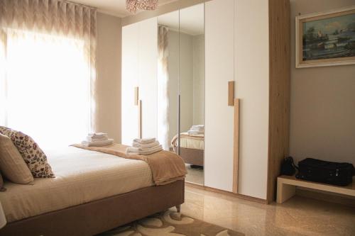 a bedroom with a bed and a large mirror at vivaldi casa vacanza in Caserta