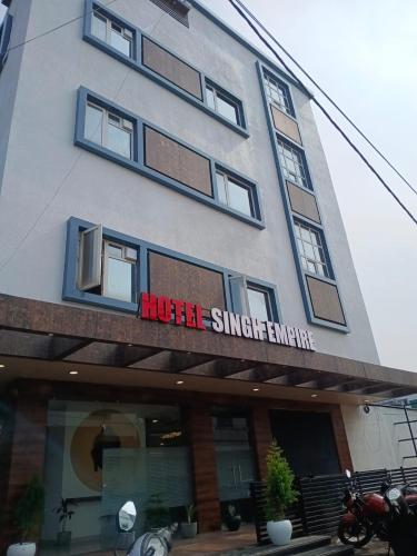 a building with a sign that reads huddle synergy emergency at Hotel Singh Empire in Sāgar