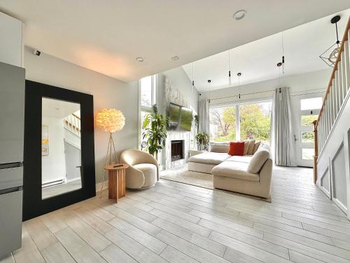 a living room with a couch and a fireplace at Arlington Beach House - by Yale in West Haven