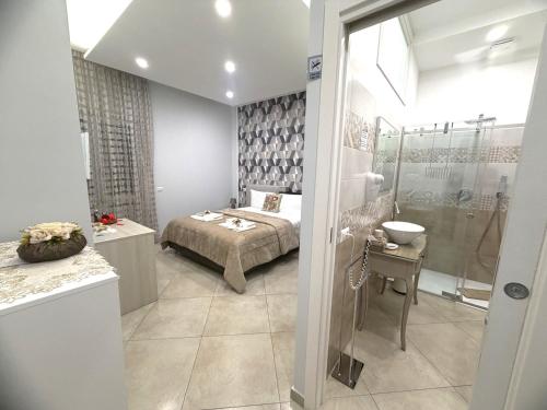 a bedroom with a bed and a shower at Olympus Pompei Ruins in Pompei