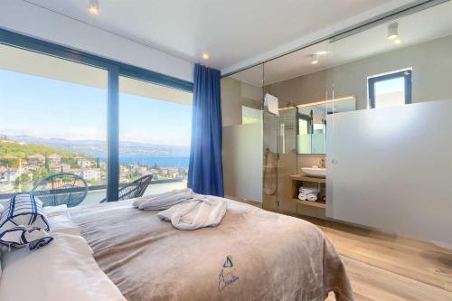 a bedroom with a bed and a large window at Villa Bella Vista 2 in Ičići