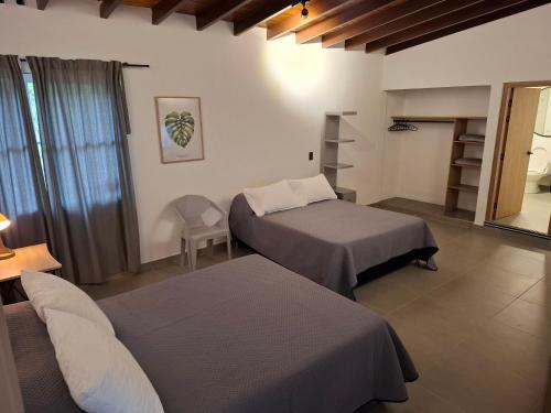 a hotel room with two beds and a window at Hotel La Casona - Cerca al Estadio Atanasio Girardot y Laureles in Medellín