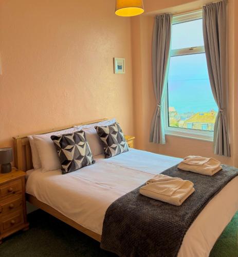 a bedroom with a bed with two towels on it at Ocean View in Ilfracombe