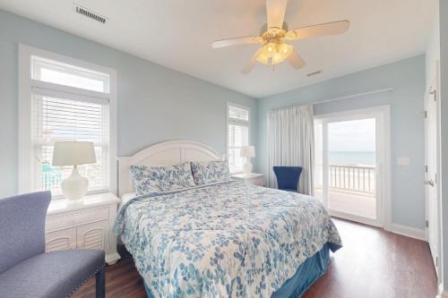 a bedroom with a bed and a ceiling fan at NTB106 Scotch Bonnet Sunrise in North Topsail Beach
