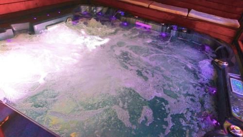 a jacuzzi tub filled with foam and water at PALMIE Gold in Palm Beach