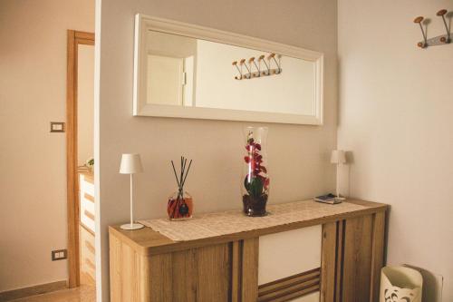 a room with a counter with a mirror on the wall at vivaldi casa vacanza in Caserta
