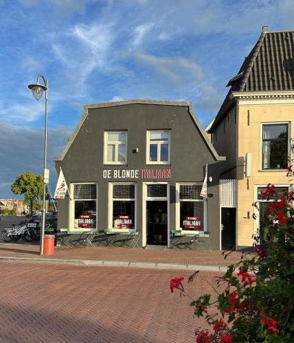 a building on the side of a street at Apartment in the city center near the Waterpoort in Sneek