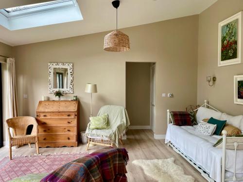 a bedroom with a bed and a dresser and a mirror at Garden House Barmeath Castle in Grangebellew
