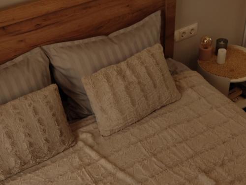 a bed with white sheets and pillows on it at ILLU Resort in Orhei