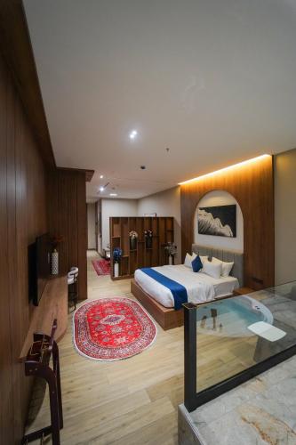 a hotel room with a bed and a glass table at Hills Managed by Dedeman in Erbil