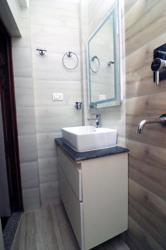 a bathroom with a sink and a mirror at New apartment in Hattigauda in Khadkagaon
