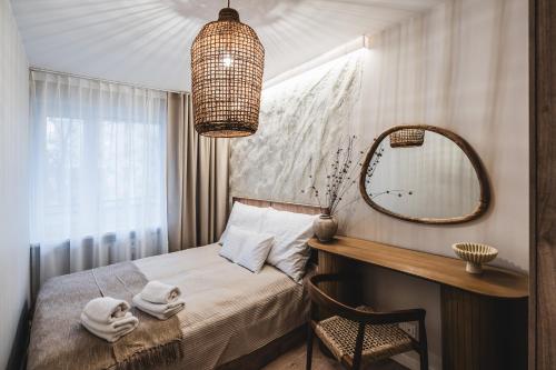 a small bedroom with a bed and a mirror at Filomacka Przestrzeń in Toruń