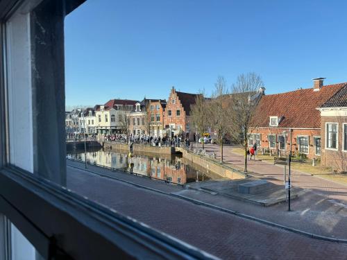a view of a river from a window at Apartment in the city center near the Waterpoort in Sneek