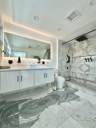 a bathroom with a sink and a toilet and a mirror at Arlington Beach House - by Yale in West Haven