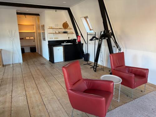 a room with two chairs and a table and a camera at Apartment in the city center near the Waterpoort in Sneek