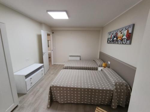 a bedroom with two beds and a sink at VUT Montse in Alcañiz