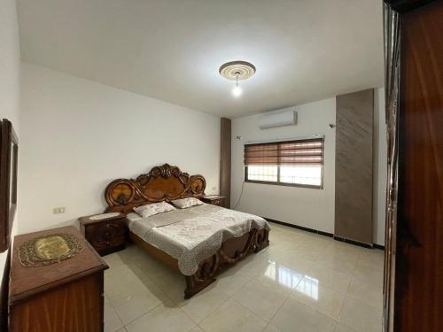 a bedroom with a large bed and a window at Jerash Skyline in Jerash