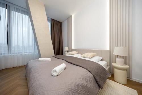 a bedroom with two beds with white towels on them at Apollo One, 1BR Signature Residence in Nivy