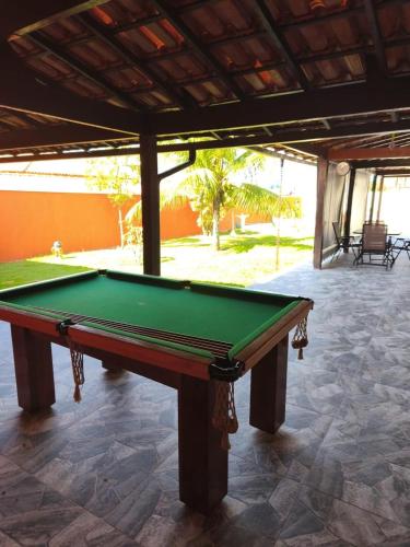 a green pool table sitting in a patio at Casa Bilbao in Maricá
