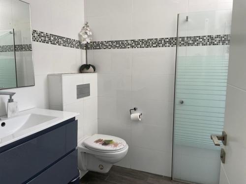 a bathroom with a toilet and a sink and a shower at Apartment with private pool in Ashkelon