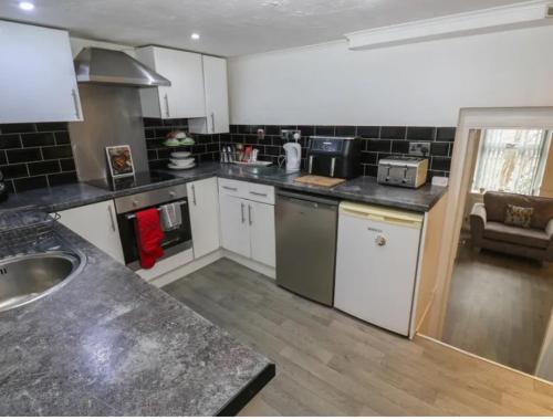 a kitchen with a sink and a counter top at Chestnut Lodge - a woodland escape near the city! in Bradford