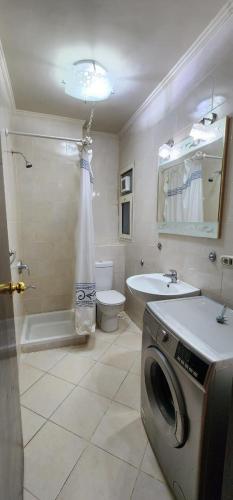 a bathroom with a washing machine in a bathroom at Porto Sokhna Pyramids - For Families Only vip in Ain Sokhna