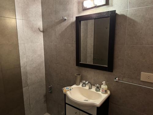 a bathroom with a sink and a mirror at Costanera 61, frente a la laguna in Chascomús
