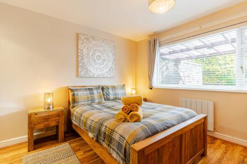 a bedroom with a bed with teddy bears on it at Acorns in Holywell