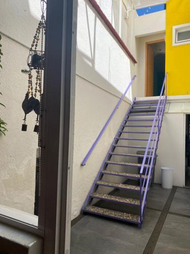 a staircase in a building with a purple railing at Casa de las Bugambilias B&B in Oaxaca City