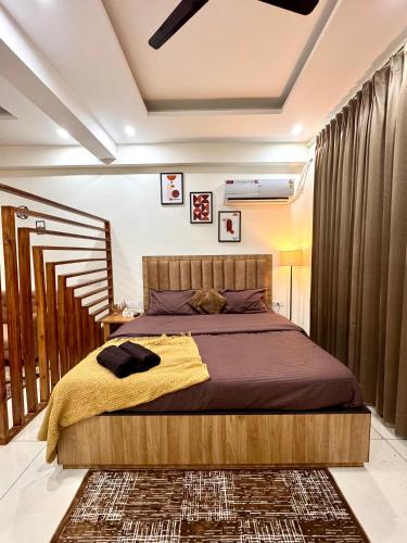a bedroom with a bed and a staircase at Luxe Label Studio by Sam in Zirakpur