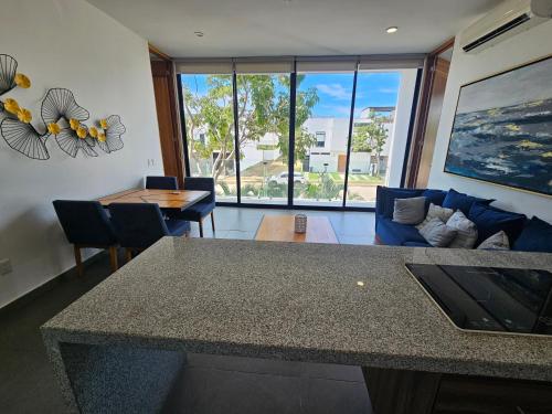 a living room with a table and a couch at Torres Mittah Oceanview Condos at La Cruz de Huanacaxtle in Cruz de Huanacaxtle