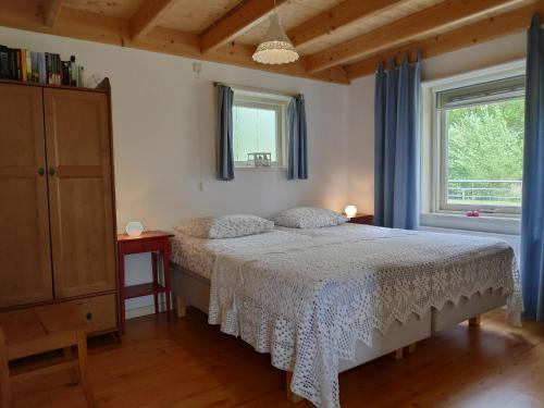 a bedroom with a bed and a window at Elferink Hoeve in Woudenberg