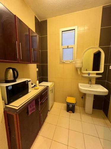 a small kitchen with a sink and a toilet at شقق دازللشقق المخدومة in Hail