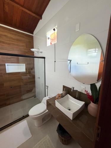 a bathroom with a sink and a toilet and a mirror at Pousada Almaré Boipeba in Ilha de Boipeba