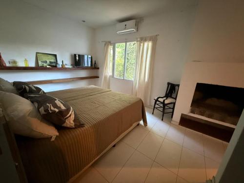 a bedroom with a bed and a fireplace at Resolana y Rinconada in Isla del Rincón