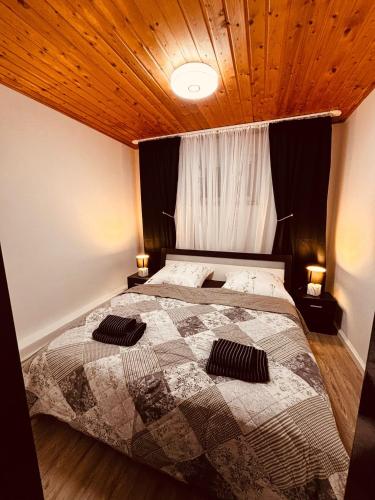 a bedroom with a bed with two pillows on it at Bad Rothenfelde Residence in Bad Rothenfelde