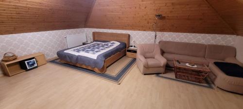 a small room with a bed and a couch at Fewo am Ith in Salzhemmendorf