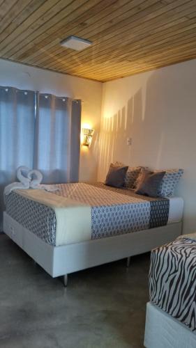 a bedroom with a large bed in a room at Pousada Cristal - Caraiva in Porto Seguro