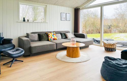 a living room with a couch and a table at 3 Bedroom Awesome Home In Haderslev in Haderslev