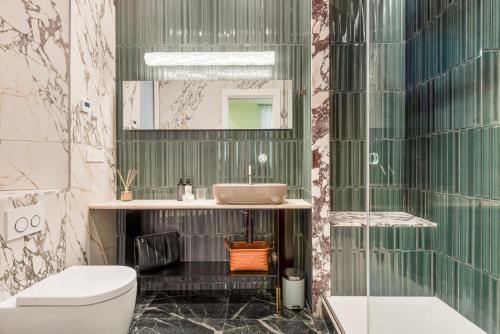 a bathroom with a sink and a toilet and a mirror at Nessun Dorma Suite in Manarola