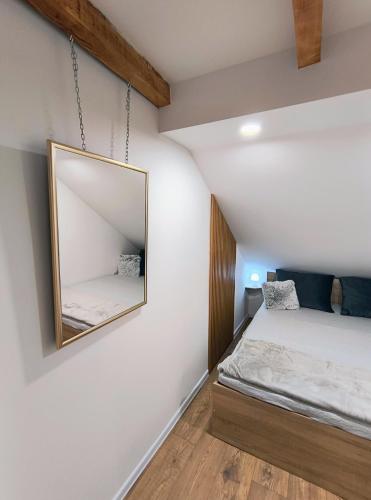 a bedroom with a mirror and a bed at Apartman Martinović in Županja