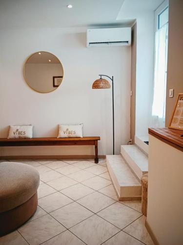 a room with a mirror and a table and stairs at Appartement cosy et confortable Chez Lyne in Laragne