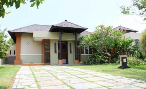 a small house with a pathway in front of it at Kalicaa Villa Resort, Tanjung Lesung in Tanjung Lesung